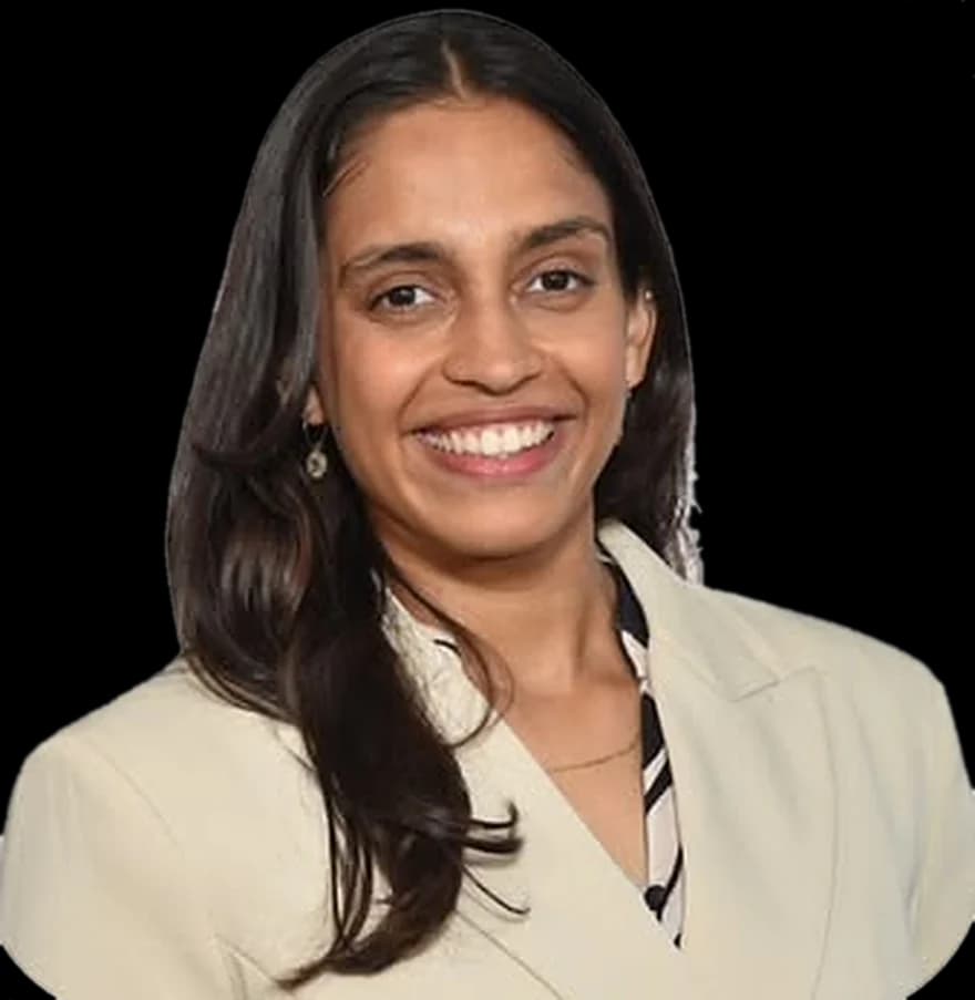 Kelley John, smiling, in a cream blazer